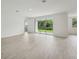 Open floor plan features neutral paint, tile floor, and sliding glass doors to the backyard at 2352 Citrus Bloom Dr, Bartow, FL 33830