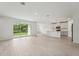Spacious living room with access to the backyard through sliding glass doors and an open kitchen at 2352 Citrus Bloom Dr, Bartow, FL 33830