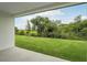 Expansive backyard view from covered patio, featuring lush green lawn and natural preserve at 2352 Citrus Bloom Dr, Bartow, FL 33830