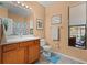 Well-lit bathroom featuring a vanity, commode, and a shower-tub combo at 2721 Village Pine Ter, Orlando, FL 32833