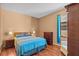 Cozy bedroom with a comfortable bed, hardwood floors, and bright natural light at 2721 Village Pine Ter, Orlando, FL 32833