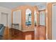 Bright foyer with hardwood floors and decorative arches leading into the living spaces at 2721 Village Pine Ter, Orlando, FL 32833