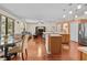 Open-concept living room and kitchen with hardwood floors and a spacious island at 2721 Village Pine Ter, Orlando, FL 32833