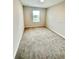 Bright bedroom with neutral paint, new carpet, and a large window at 2834 Narcoossee Commons Way, St Cloud, FL 34771
