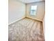 Bright bedroom featuring neutral walls, plush carpeting, and a window for natural light at 2834 Narcoossee Commons Way, St Cloud, FL 34771