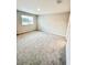 A well-lit bedroom has neutral paint, plush carpet, and a window at 2834 Narcoossee Commons Way, St Cloud, FL 34771