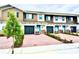 Charming townhouse exteriors with modern garage doors, brick driveways, and colorful front doors at 2834 Narcoossee Commons Way, St Cloud, FL 34771