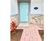 Inviting front entrance with a vibrant blue door, stone accents, and red landscaping that enhances curb appeal at 2834 Narcoossee Commons Way, St Cloud, FL 34771