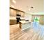 Beautiful kitchen with an island sink, wood flooring, stainless steel appliances, and ample cabinetry at 2834 Narcoossee Commons Way, St Cloud, FL 34771
