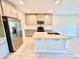 Well-lit kitchen with stainless steel appliances, island with sink, and bright cabinets for ample storage at 2834 Narcoossee Commons Way, St Cloud, FL 34771