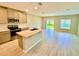 Bright open kitchen with an island featuring a sink, stainless steel appliances, and lots of cabinet space at 2834 Narcoossee Commons Way, St Cloud, FL 34771
