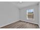 Sunlit bedroom featuring wood-look floors and a large window for natural light at 6218 Forsythe Loop, Sanford, FL 32771