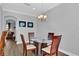 Elegant dining area with hardwood floors, modern lighting fixture, and seating for four guests at 6218 Forsythe Loop, Sanford, FL 32771