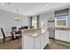 Open-concept kitchen and dining area featuring stainless steel appliances, hardwood floors, and modern lighting at 6218 Forsythe Loop, Sanford, FL 32771