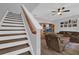 Cozy living room with hardwood floors, ceiling fan, and comfortable furniture, adjacent to the staircase at 6218 Forsythe Loop, Sanford, FL 32771