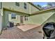 View of a private brick patio with an air conditioner and covered grill near the back door at 6218 Forsythe Loop, Sanford, FL 32771