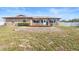 View of brick home with a brick patio and access to spacious backyard with white fencing at 947 N Atmore Cir, Deltona, FL 32725