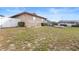 Brick home features a spacious backyard with white fence and a raised deck area at 947 N Atmore Cir, Deltona, FL 32725