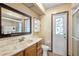Bathroom features a granite-look vanity, decorative door, shower, and convenient storage space at 947 N Atmore Cir, Deltona, FL 32725