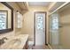 Clean bathroom featuring vanity, commode, tiled floor, and shower with glass doors at 947 N Atmore Cir, Deltona, FL 32725