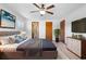 Spacious bedroom featuring a ceiling fan, closet and ensuite bath access at 947 N Atmore Cir, Deltona, FL 32725
