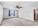 Spacious bedroom with neutral carpet, ceiling fan, and natural light from the window at 947 N Atmore Cir, Deltona, FL 32725