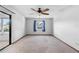 Large bedroom with ceiling fan, natural light, and sliding glass door at 947 N Atmore Cir, Deltona, FL 32725
