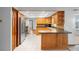 Spacious eat-in kitchen featuring wood cabinetry, stainless steel appliances, and tile flooring at 947 N Atmore Cir, Deltona, FL 32725