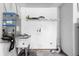 Functional laundry room with utility sink, shelving, and washer/dryer hookups for convenience at 947 N Atmore Cir, Deltona, FL 32725