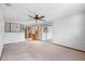 Open living room with a ceiling fan and sliding glass doors at 947 N Atmore Cir, Deltona, FL 32725