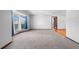 Inviting living room with plush carpeting, large bay window, and an open doorway at 947 N Atmore Cir, Deltona, FL 32725
