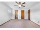 Spacious main bedroom features a ceiling fan, neutral carpet, and three interior doors at 947 N Atmore Cir, Deltona, FL 32725