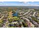 Aerial view of a beautiful neighborhood with mature trees and a lake at 1056 Royal Saint George Dr, Orlando, FL 32828