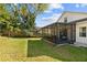 Backyard featuring a screened patio, green grass and a privacy fence at 1056 Royal Saint George Dr, Orlando, FL 32828