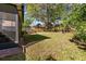 Well maintained backyard with green grass, a mature tree and a screened-in porch at 1056 Royal Saint George Dr, Orlando, FL 32828