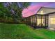 Backyard featuring an enclosed patio with a large grassy lawn at 1056 Royal Saint George Dr, Orlando, FL 32828