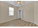 Bedroom with wood-look floors, closet, window, and neutral paint for a customizable space at 1056 Royal Saint George Dr, Orlando, FL 32828