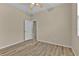 Bedroom featuring wood-look floors, neutral paint, ceiling fan, and view to additional rooms at 1056 Royal Saint George Dr, Orlando, FL 32828