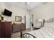 Bright bedroom with light colored walls features a vintage dresser and view to an adjacent room at 1056 Royal Saint George Dr, Orlando, FL 32828