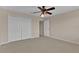 Neutral bedroom featuring a ceiling fan, large closet and carpeted floor at 1056 Royal Saint George Dr, Orlando, FL 32828