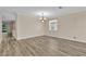 Dining room showcasing modern floors and natural light from a large window at 1056 Royal Saint George Dr, Orlando, FL 32828