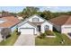 Charming one-story home featuring a well-manicured lawn, attached two-car garage, and inviting curb appeal at 1056 Royal Saint George Dr, Orlando, FL 32828