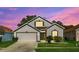 Charming two-story home with manicured lawn and attached two car garage at 1056 Royal Saint George Dr, Orlando, FL 32828