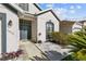 Close-up of the home's front entrance with a decorative front door and manicured landscaping at 1056 Royal Saint George Dr, Orlando, FL 32828