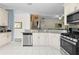 Bright kitchen with white cabinets, stainless steel appliances, granite countertops, and tile flooring at 1056 Royal Saint George Dr, Orlando, FL 32828