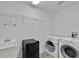 Clean laundry room featuring a utility sink, washer, dryer, and wire shelving at 1056 Royal Saint George Dr, Orlando, FL 32828