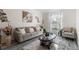 Cozy living room with plush sofa, decor, large window, and hardwood flooring at 1056 Royal Saint George Dr, Orlando, FL 32828