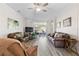Spacious living room with hardwood floors, comfortable seating, and a sliding glass door at 1056 Royal Saint George Dr, Orlando, FL 32828