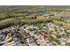 Panoramic aerial of the neighborhood showcasing the house's position among nearby homes and natural features at 1056 Royal Saint George Dr, Orlando, FL 32828