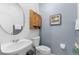Cozy half-bath features a pedestal sink, toilet, and stylish decor, maximizing both functionality and aesthetic appeal at 1056 Royal Saint George Dr, Orlando, FL 32828